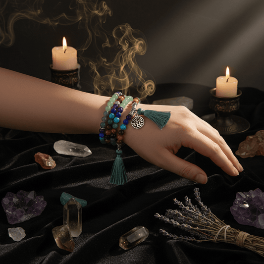 Multicolored beaded bracelet with a tassel and tree of life charm on a wrist.