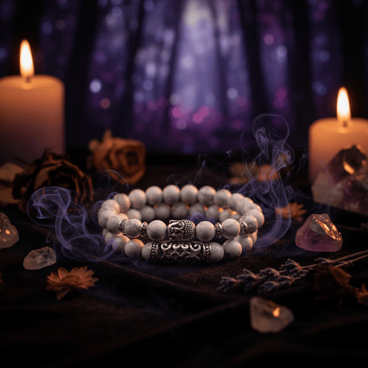 Set of white and gray beaded bracelets with silver Buddha charm on a white background