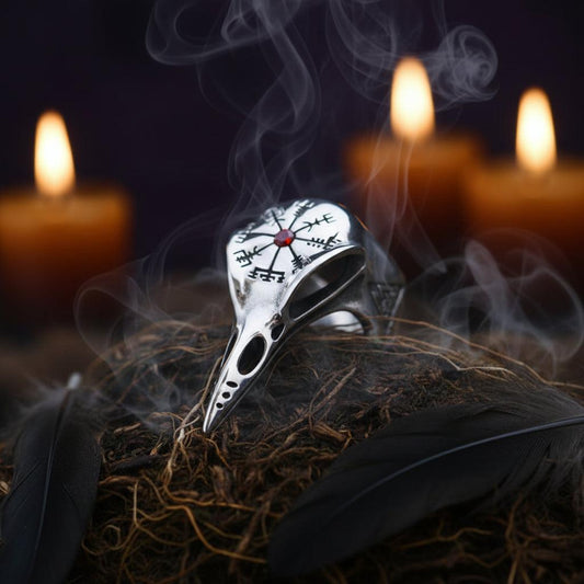 Silver ring with intricate designs on a textured surface