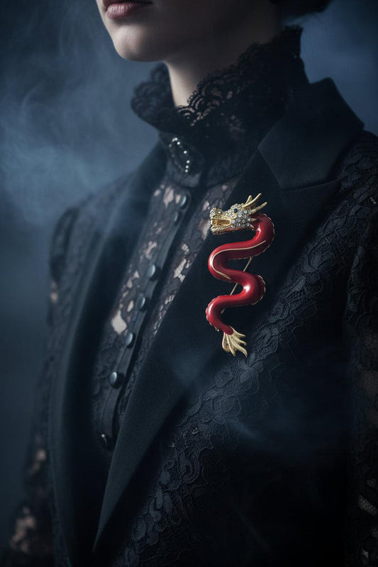 Red dragon brooch with gold crown on a white background