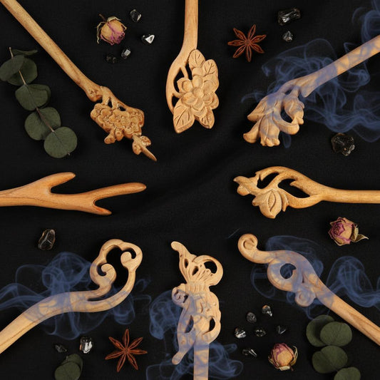 Decorative wooden sticks with intricate carvings on a black background