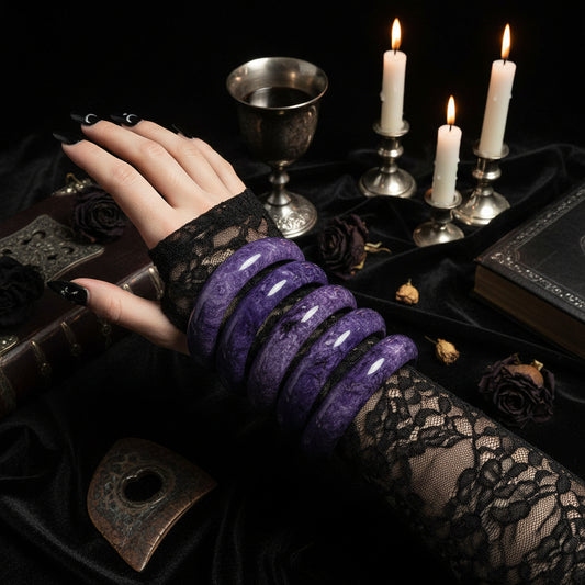 Purple bracelets on a white surface with a remote control in the background
