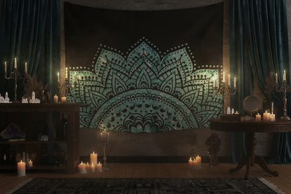 Teal and black mandala tapestry hanging on a wall in a room with wooden floor and decor.