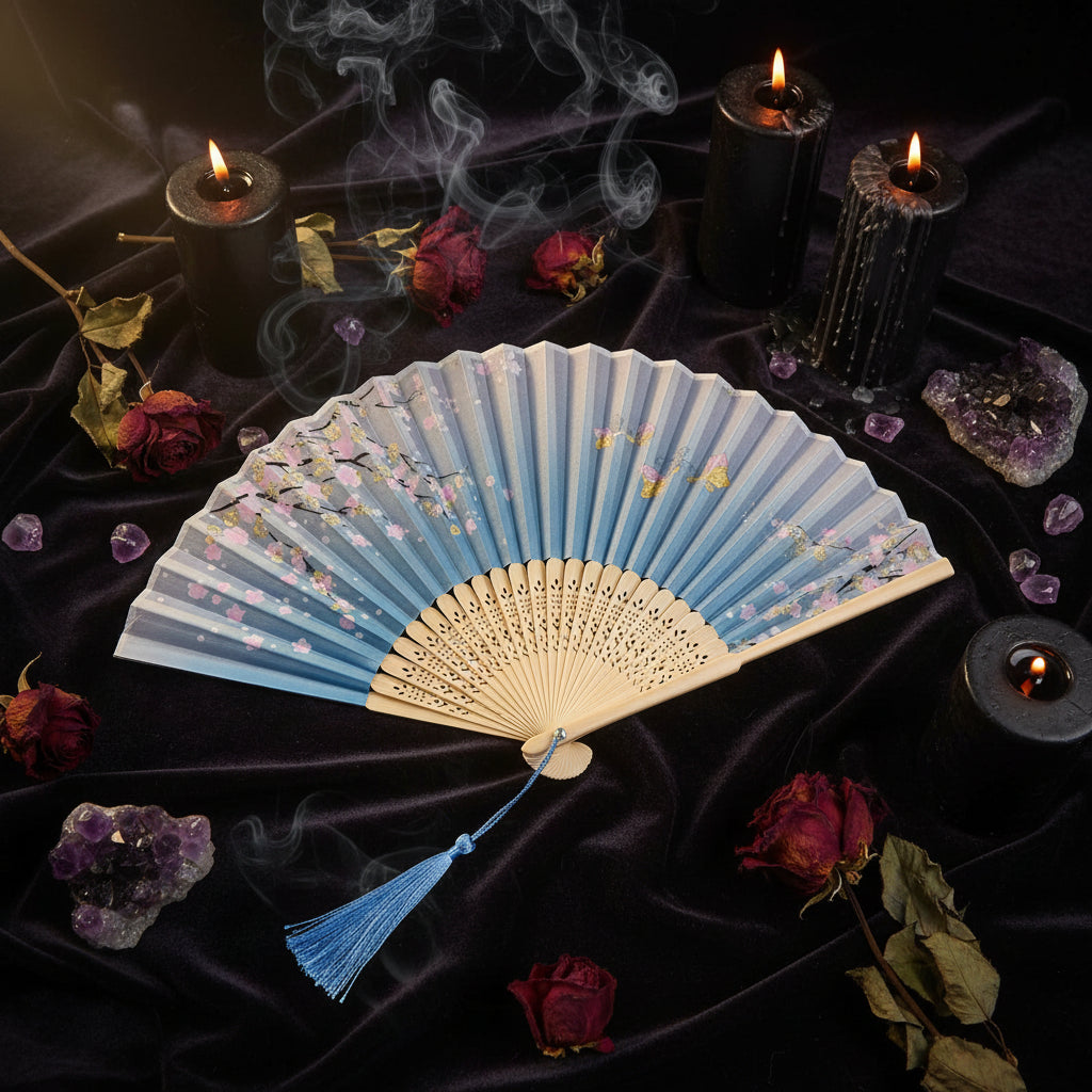 Traditional folding fan with floral design on a light background