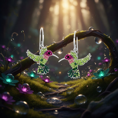 Hummingbird-shaped earrings with green and pink details on a white background