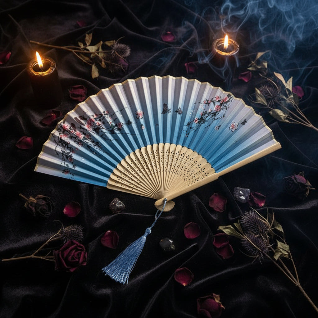 Decorative folding fan with floral design on a light background