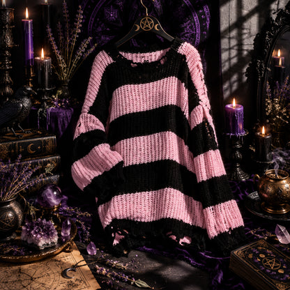 Person wearing a pink and black striped sweater in front of a mirror.