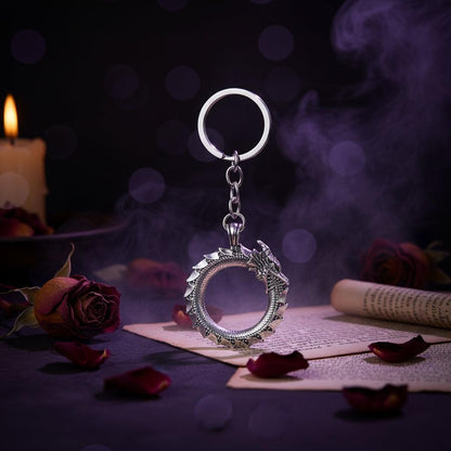 Silver keychain with circular design on a white background