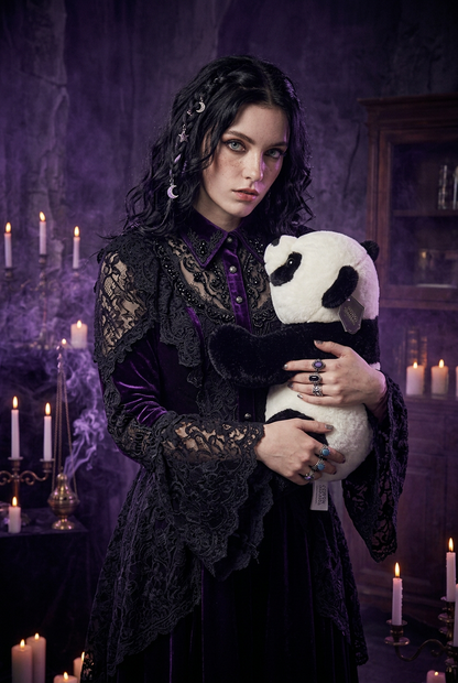 A young girl with braided hair holds a large black and white panda plush toy in a brightly lit room. She is wearing a white graphic t-shirt and denim shorts.