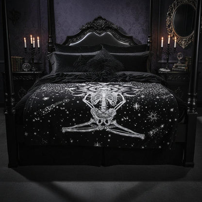 A black tapestry featuring a white celestial skeleton design with a sun, moon phases, and stars, hanging on a wall above a wooden floor with decorative vases and a picture frame.