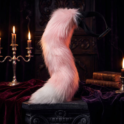 Pink and white fox tail with a black band on a white background