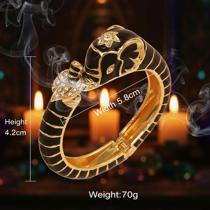 Black and gold snake-shaped ring with measurements on a white background