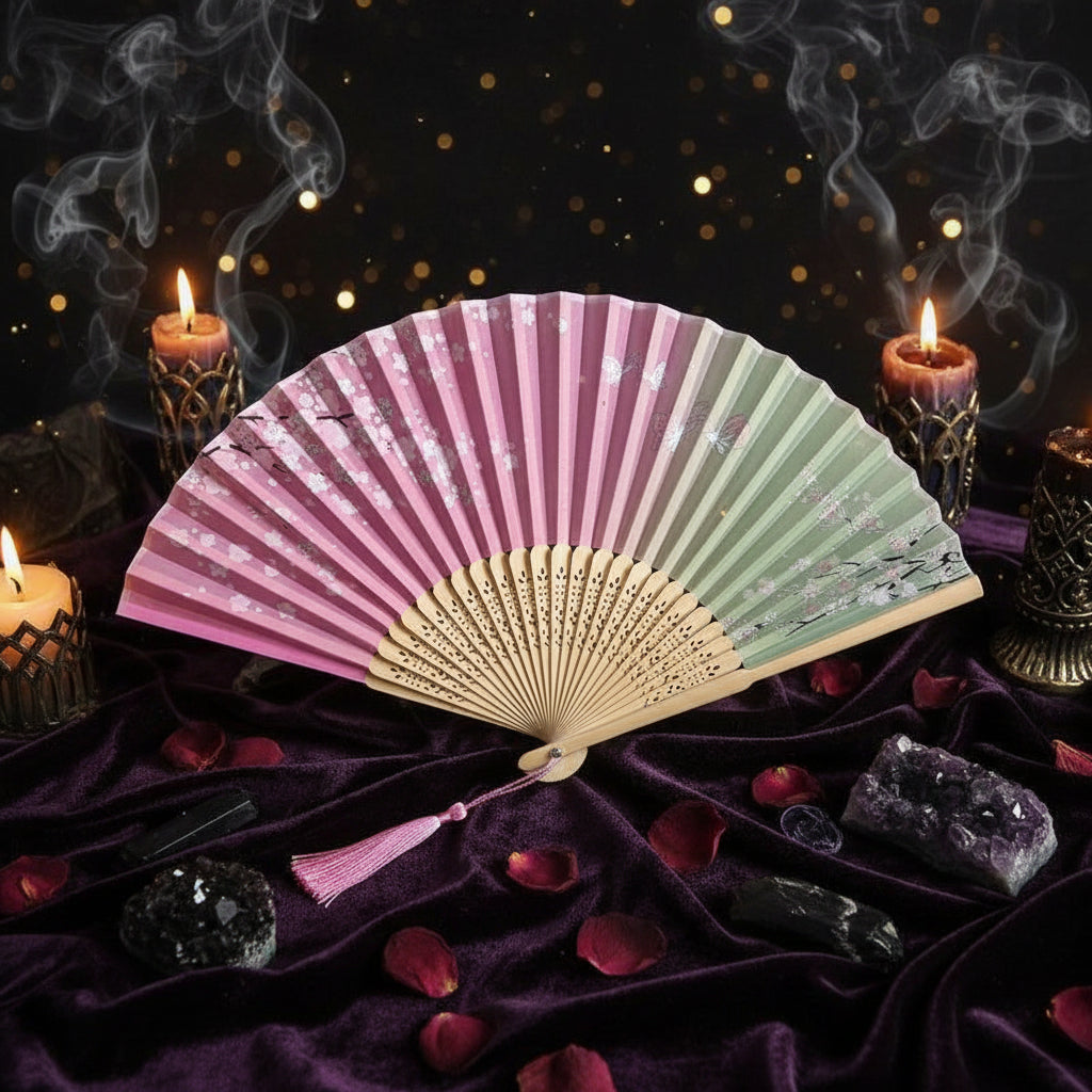 Colorful folding fan with floral decorations on a light background