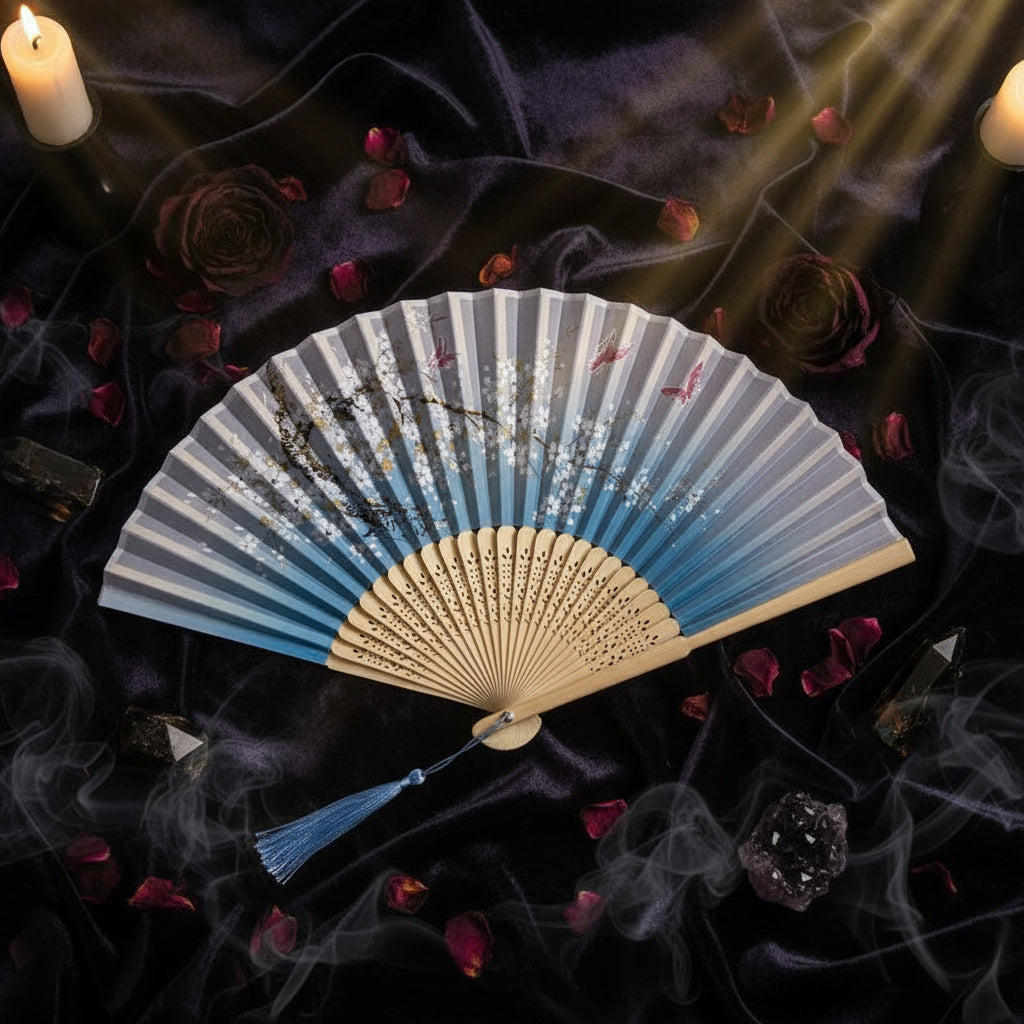 Handheld fan with artistic design on a white background with pink flowers