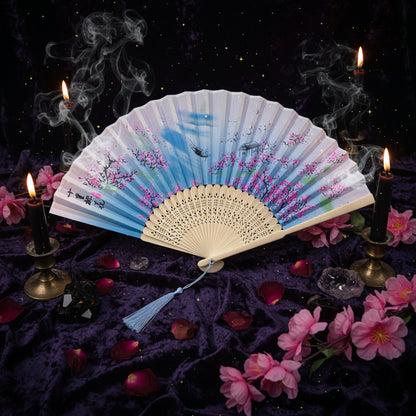Decorative folding fan with floral design on a white background