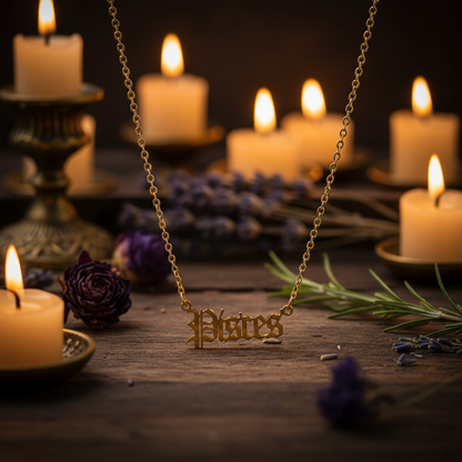 A gold chain necklace featuring a gothic-style script pendant that reads 'Pisces', displayed against a solid black background.