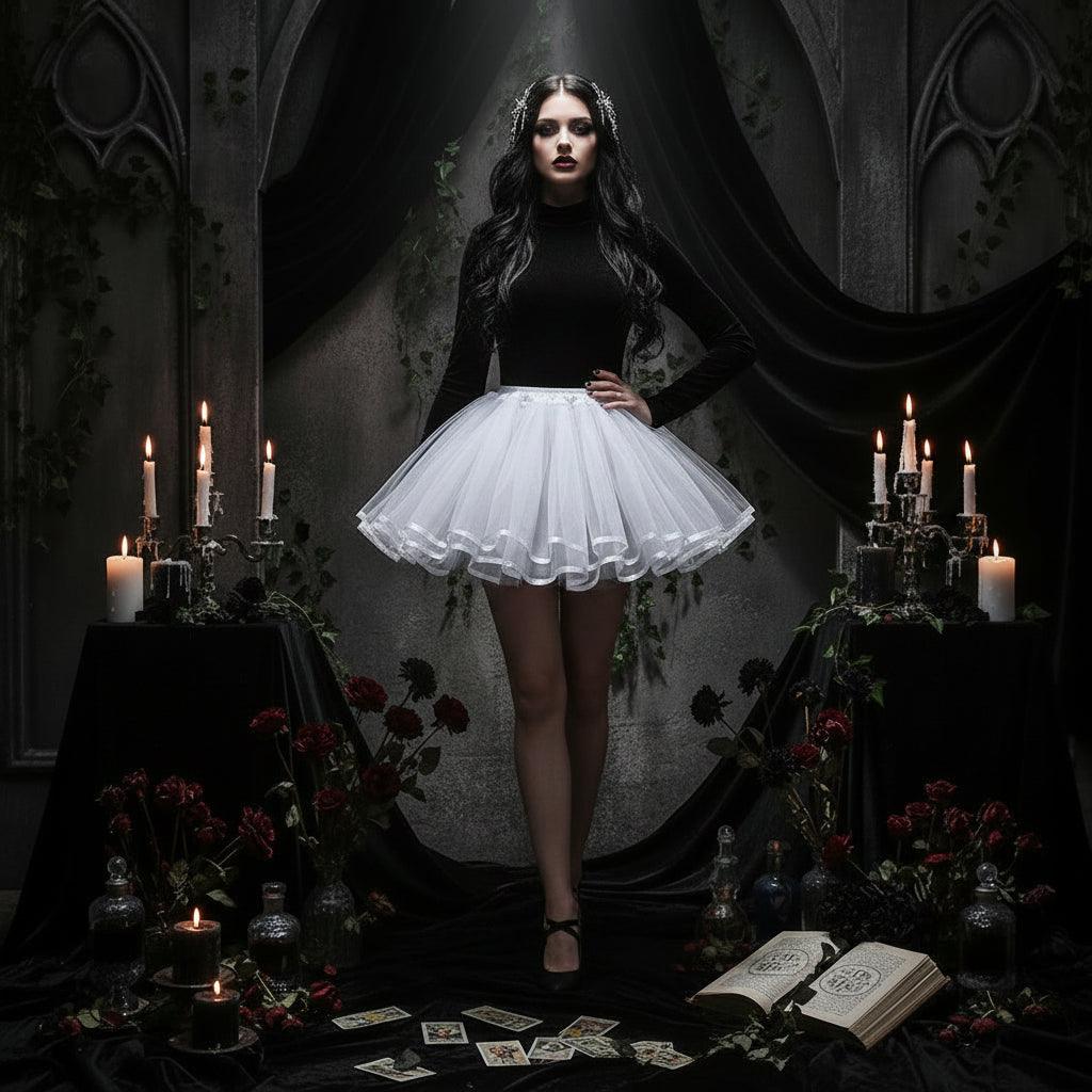 A white tutu skirt displayed on a white dress form mannequin stand in a bright, white-themed room with a chair and cabinet in the background.