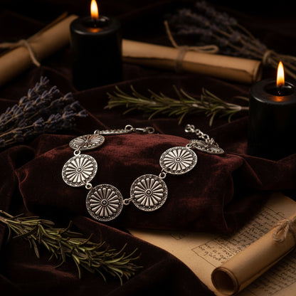 Silver circular earrings on a white background