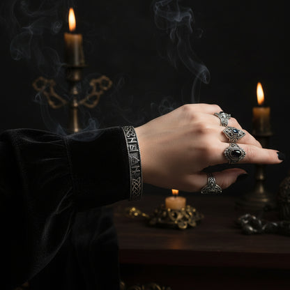 Silver bracelet withRunes and a triangle symbol on a white background