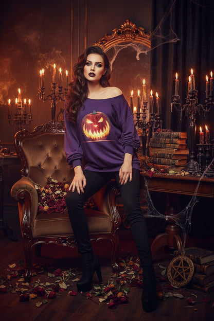 A purple off-the-shoulder long-sleeve sweatshirt featuring a large graphic print of a glowing jack-o'-lantern pumpkin on the front, set against a plain white background.