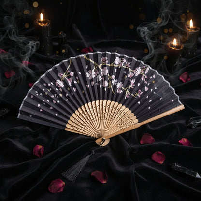 Handheld fan with floral design on a white background with pink flowers
