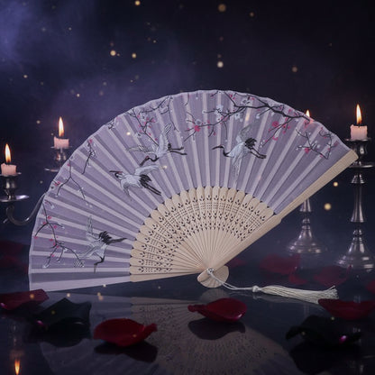 Handheld fan with cherry blossom and crane design on a white background