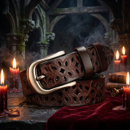 Brown leather belt with intricate floral patterns and a silver buckle on a wooden surface.