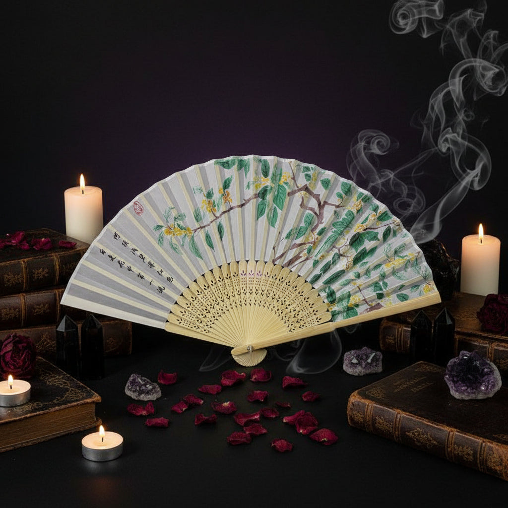 Handheld fan with floral design on a white tray