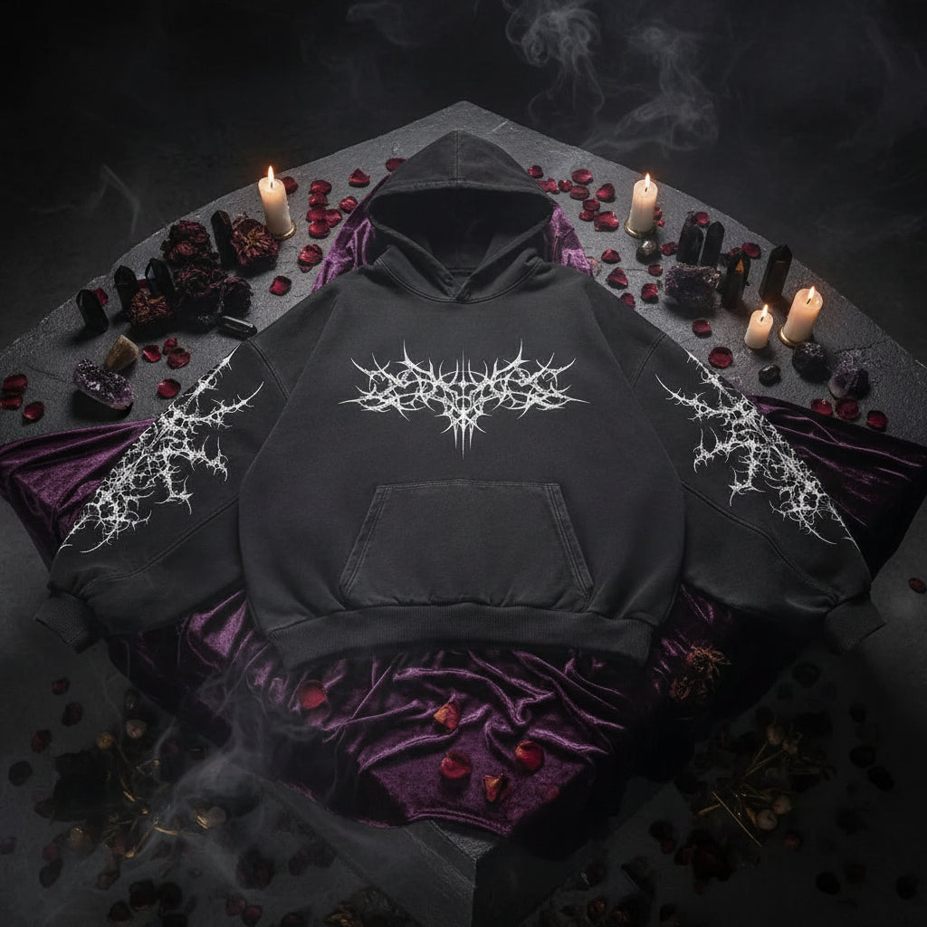 Black hoodie with intricate designs on a gray background