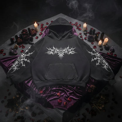 Black hoodie with intricate designs on a gray background