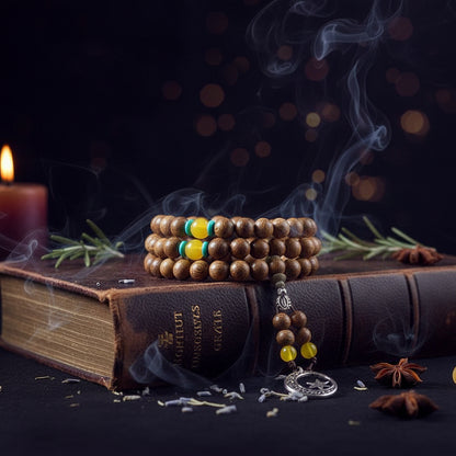 Wooden beaded bracelet with yellow and green beads on a book