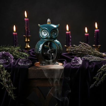 Blue owl-shaped incense burner on a wooden base with text about technology and style.