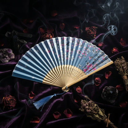 Traditional folding fan with floral design on a light background