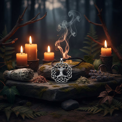 Silver tree of life pendant on a black cord against a wooden background