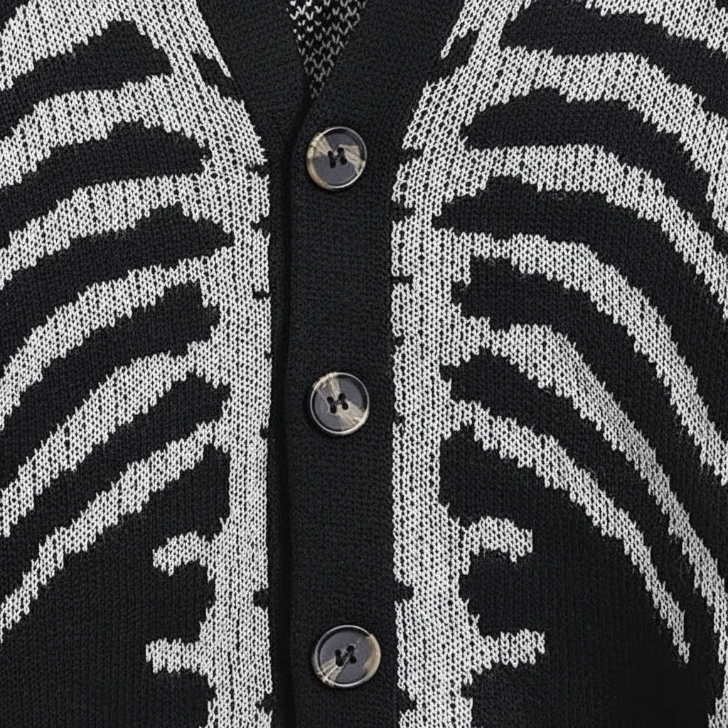 Close-up of a black and white patterned cardigan with button details.