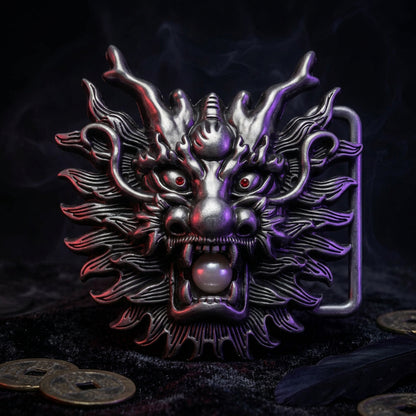 A metallic dragon head belt buckle with red eyes and a pearl-like bead in its mouth, shown on a plain white background.