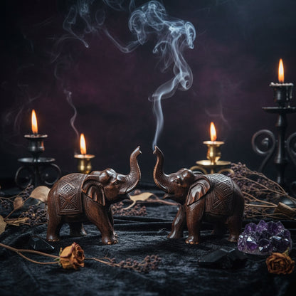 Two wooden elephant figurines on a surface with text about imported logs from Africa and polished finish.