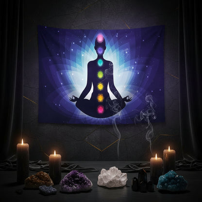 Tapestry with a silhouette of a meditating figure with chakra colors in a living room setting.