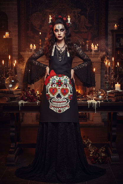Black apron with a colorful skull design and red bow on a white background