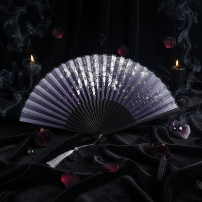 Black folding fan with decorative design on a white background with pink flowers