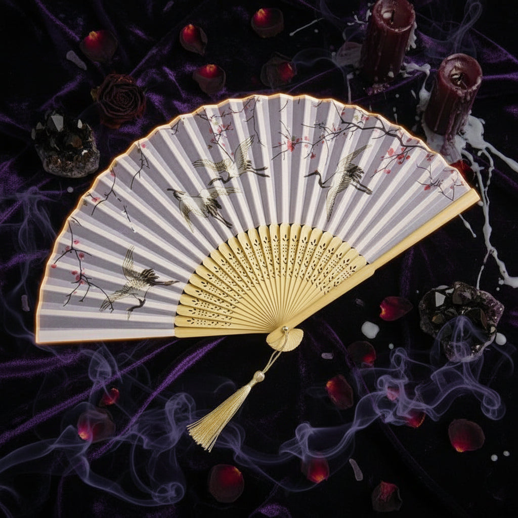 Traditional Chinese folding fan with floral design on a light background