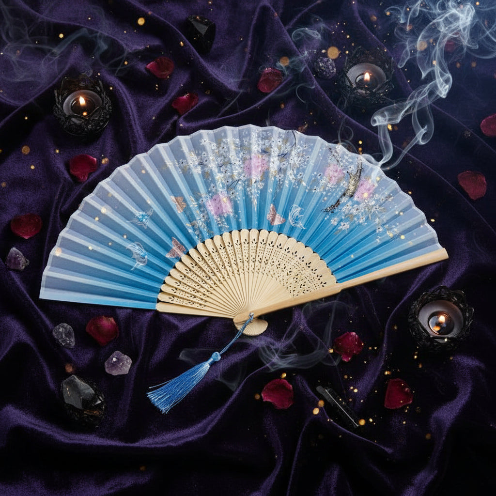 Light blue and beige fan with floral design on a white background with pink flowers.