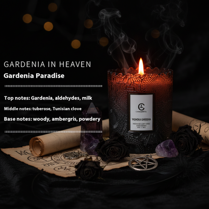 Black candle labeled 'Yashika Gardenia' with fragrance description on a white background