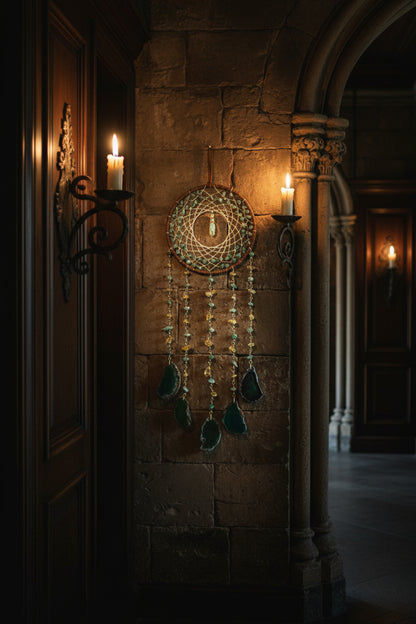 Decorative dreamcatcher with green stone elements on a white background