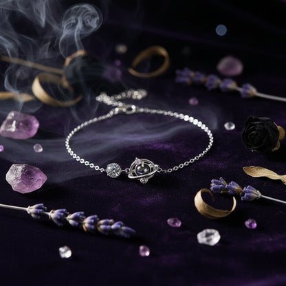 Silver necklace with a pendant held between fingers against a neutral background