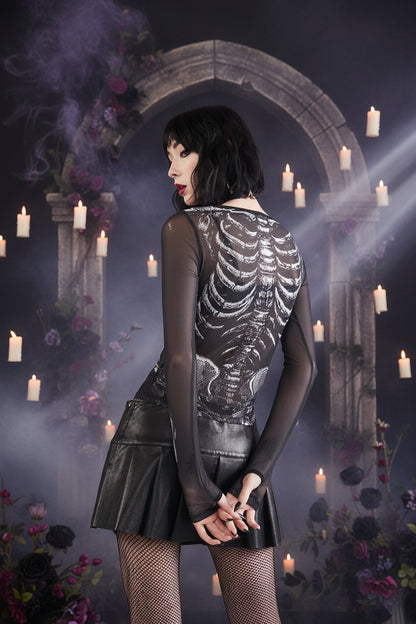 Person wearing a black dress with skeleton design on a white background