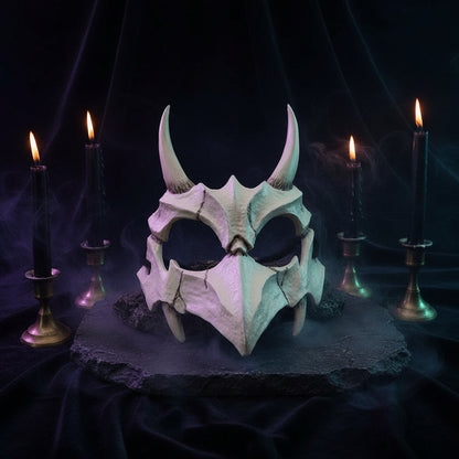 A white dragon skull mask with curved horns and textured bone-like details, photographed against a dark black background.