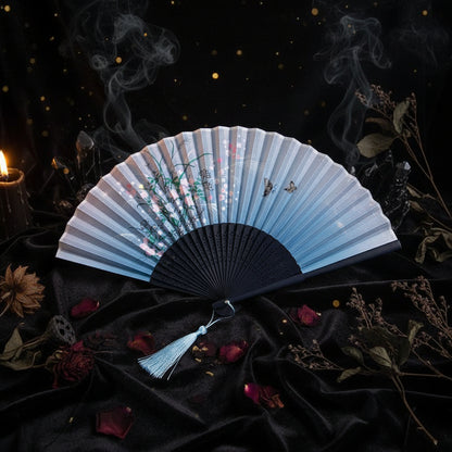 Traditional Chinese folding fan with floral design on a white background