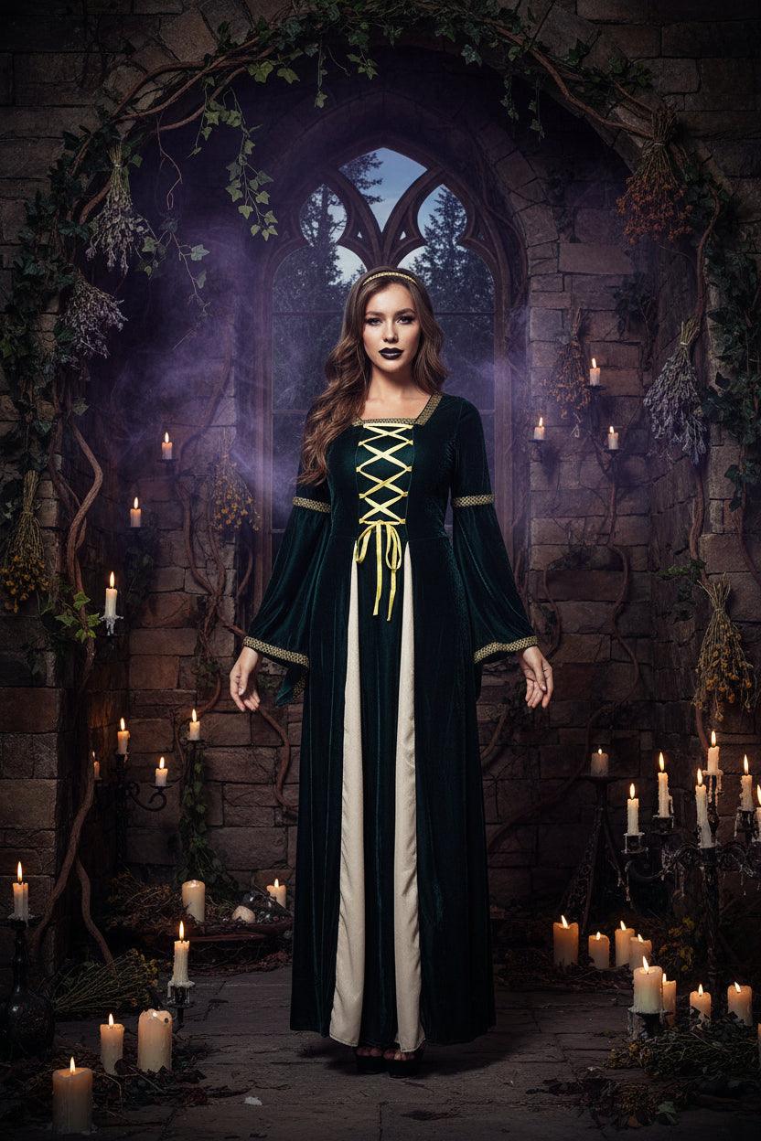 A woman modeling a medieval-style long dress costume. The dress features a dark forest green velvet outer layer with yellow lace-up detailing at the chest, a cream-colored inner layer, and gold trim on the cuffs and waist.