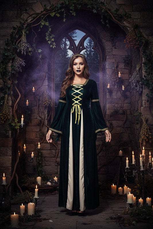 A woman modeling a medieval-style long dress costume. The dress features a dark forest green velvet outer layer with yellow lace-up detailing at the chest, a cream-colored inner layer, and gold trim on the cuffs and waist.